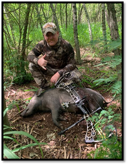 Photo of a hunter and pig